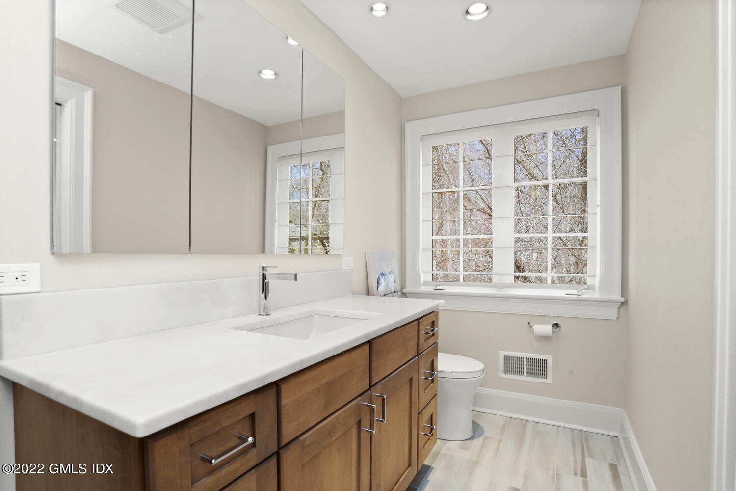 7 Owenoke Way Riverside, CT 06878 - Photo 23 of 37 a bathroom with a sink a toilet a vanity and a window