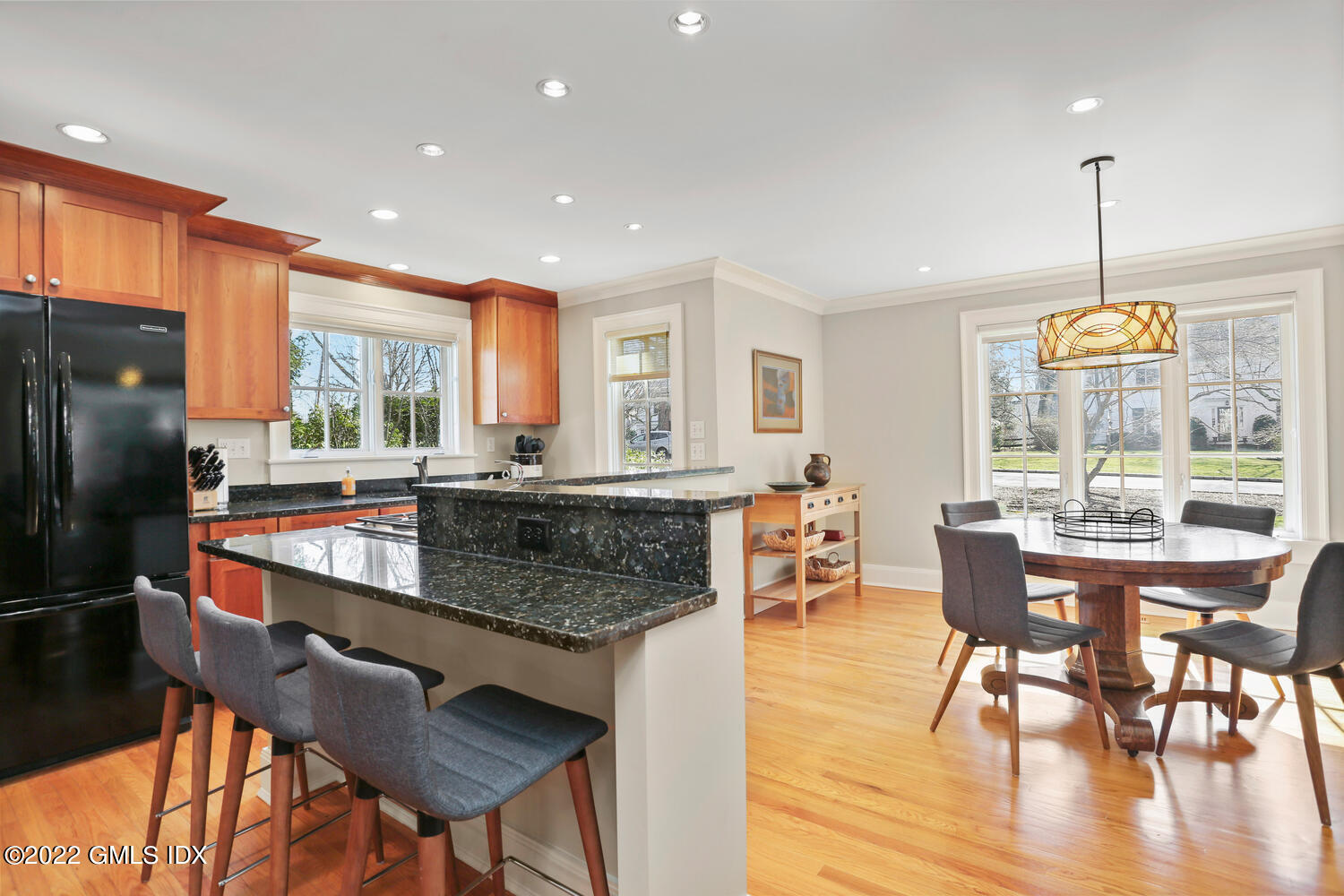 7 Owenoke Way Riverside, CT 06878 - Photo 8 of 37 a kitchen with stainless steel appliances granite countertop a stove a sink a refrigerator a dining table and chairs with wooden floor