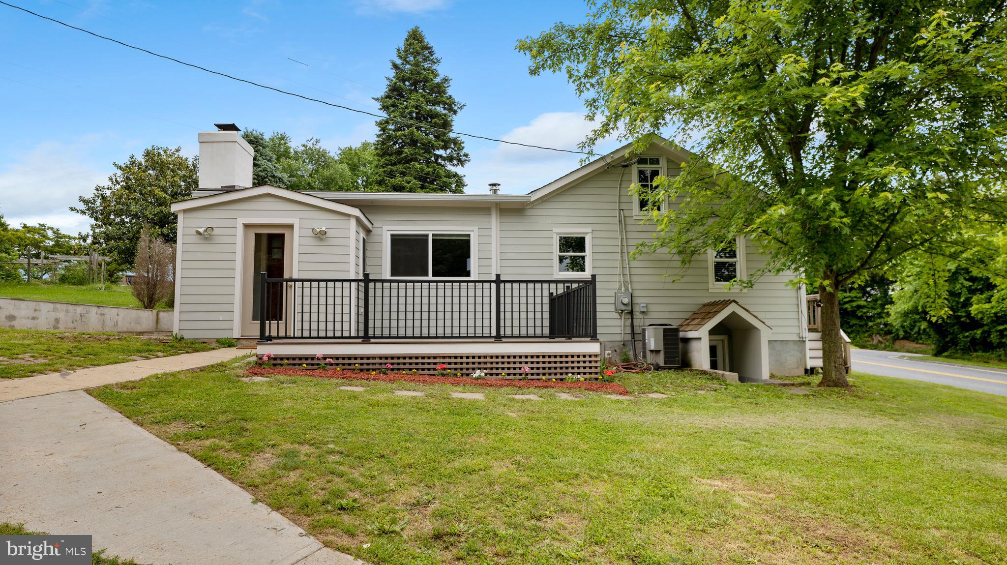 15705 Barnesville Road Boyds, MD 20841 - Photo 1 of 49 a view of a white house with a small yard and large trees