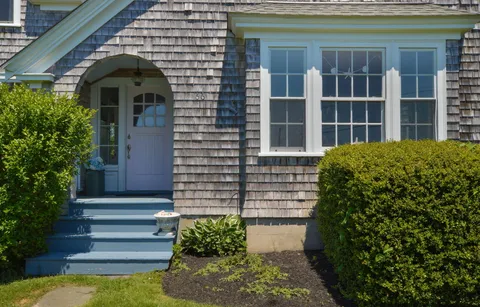 a front view of a house with a garden
