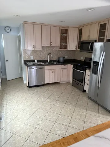 a bathroom with a granite countertop sink a toilet and shower