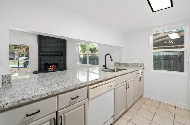 a kitchen with stainless steel appliances granite countertop a sink and a wooden cabinets