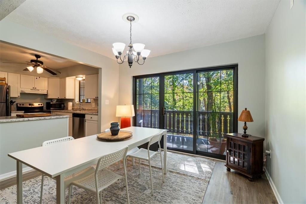 703 Timber Lane Sewickley, PA 15143 - Photo 12 of 30 a kitchen with stainless steel appliances granite countertop a stove a sink a dining table and chairs