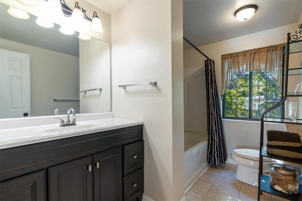 703 Timber Lane Sewickley, PA 15143 - Photo 25 of 30 a bathroom with a double vanity sink toilet and a mirror