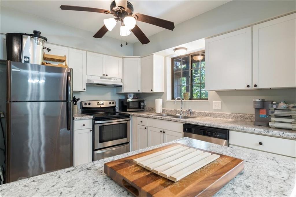 703 Timber Lane Sewickley, PA 15143 - Photo 8 of 30 a kitchen with a refrigerator and a stove top oven