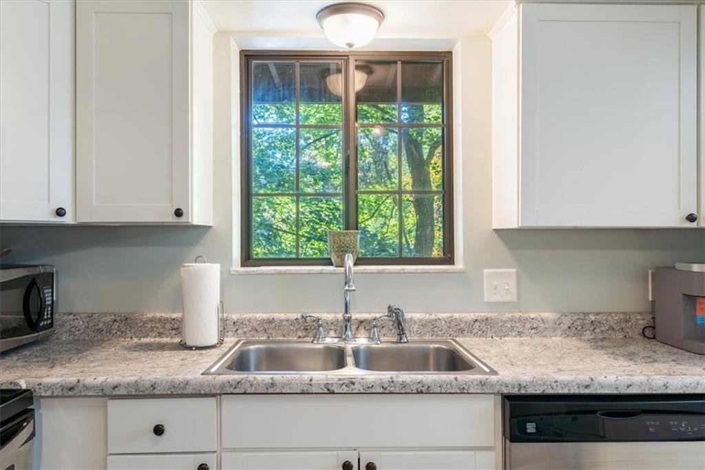 703 Timber Lane Sewickley, PA 15143 - Photo 9 of 30 a kitchen with granite countertop a sink and a window