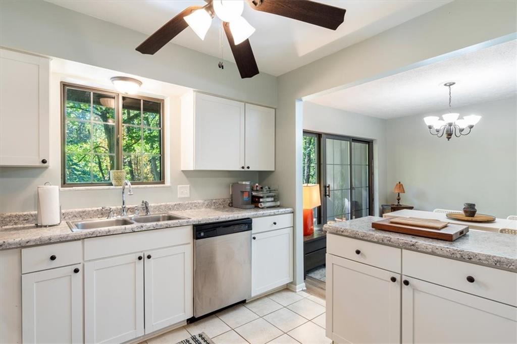 703 Timber Lane Sewickley, PA 15143 - Photo 10 of 30 a kitchen with a sink dishwasher a stove and white cabinets with wooden floor