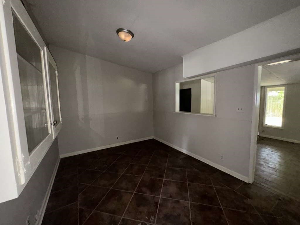 270 Triangle Drive Vidor, TX 77662 - Photo 16 of 27 a view of an empty room with wooden floor and a window