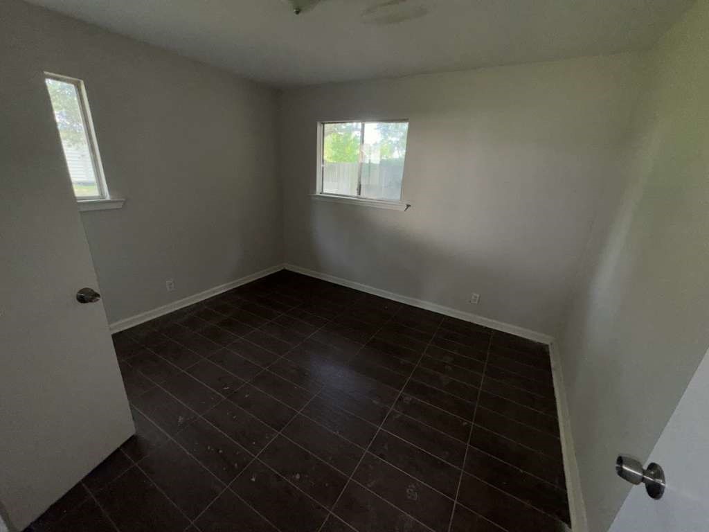 270 Triangle Drive Vidor, TX 77662 - Photo 25 of 29 an empty room with wooden floor and windows