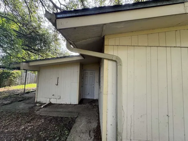 a view of a house with a backyard and garage