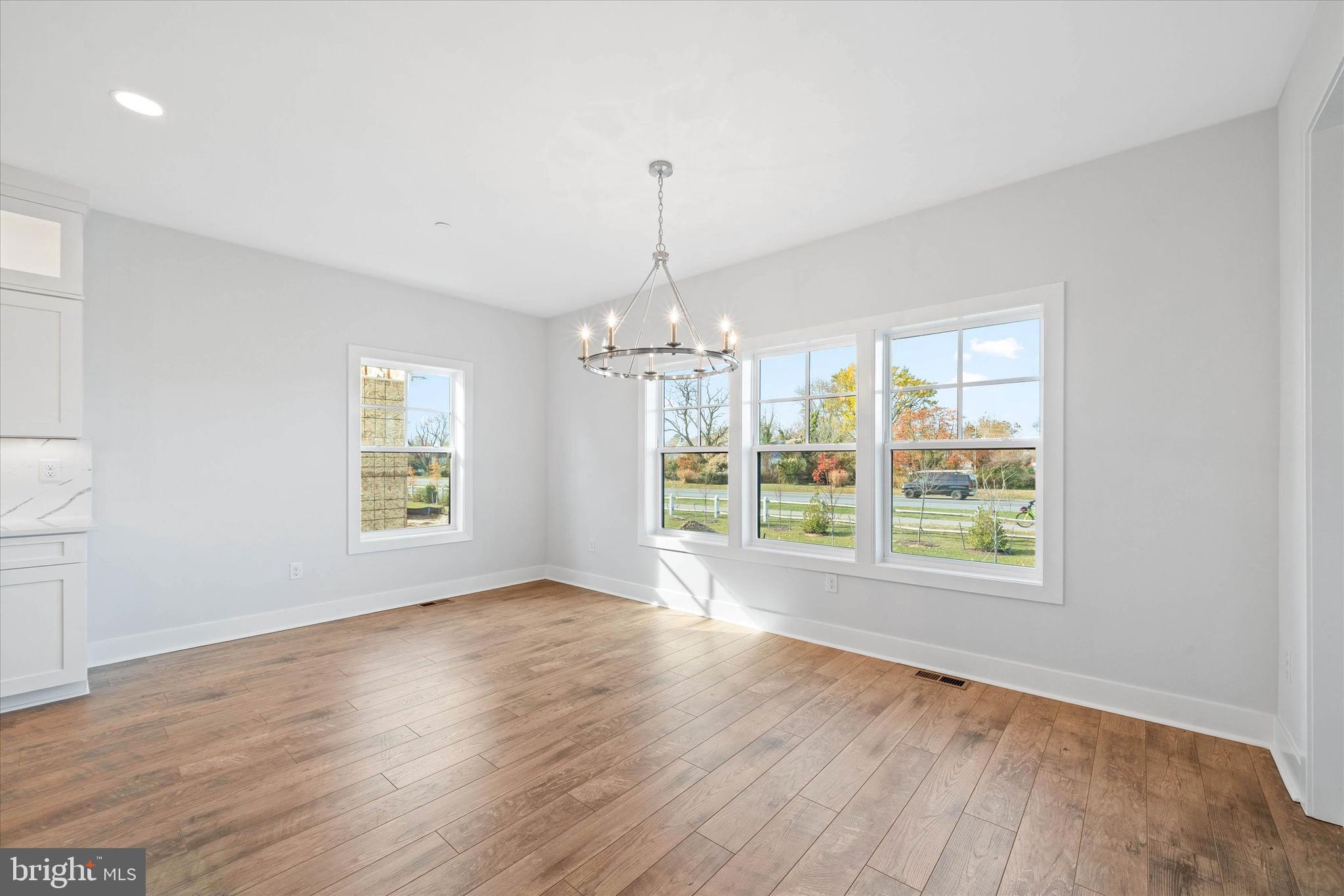 11809 River Run Lane Berlin, MD 21811 - Photo 38 of 95 a view of an empty room with wooden floor and a window