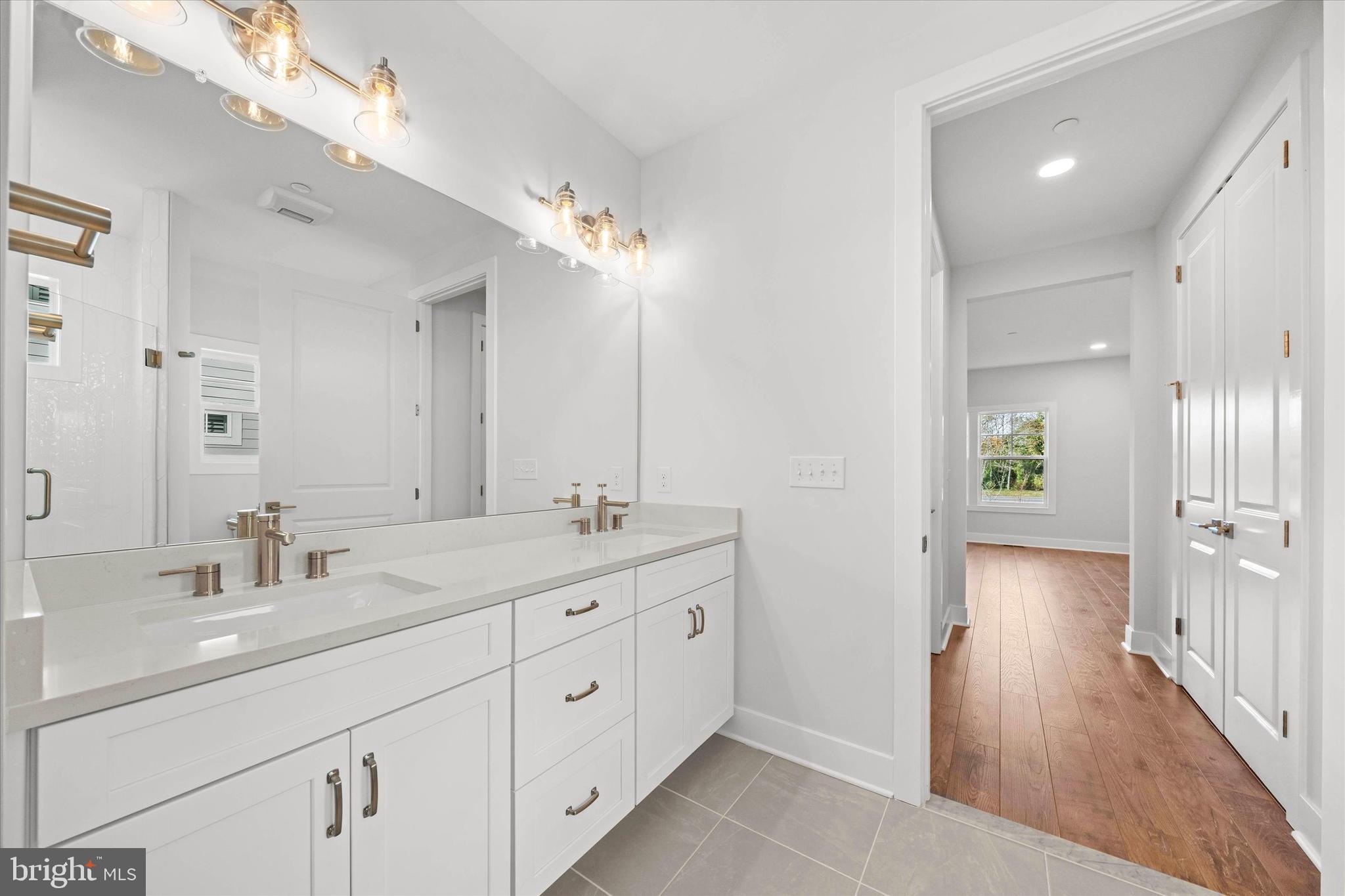 11809 River Run Lane Berlin, MD 21811 - Photo 48 of 95 a spacious bathroom with a double vanity sink a mirror and a shower