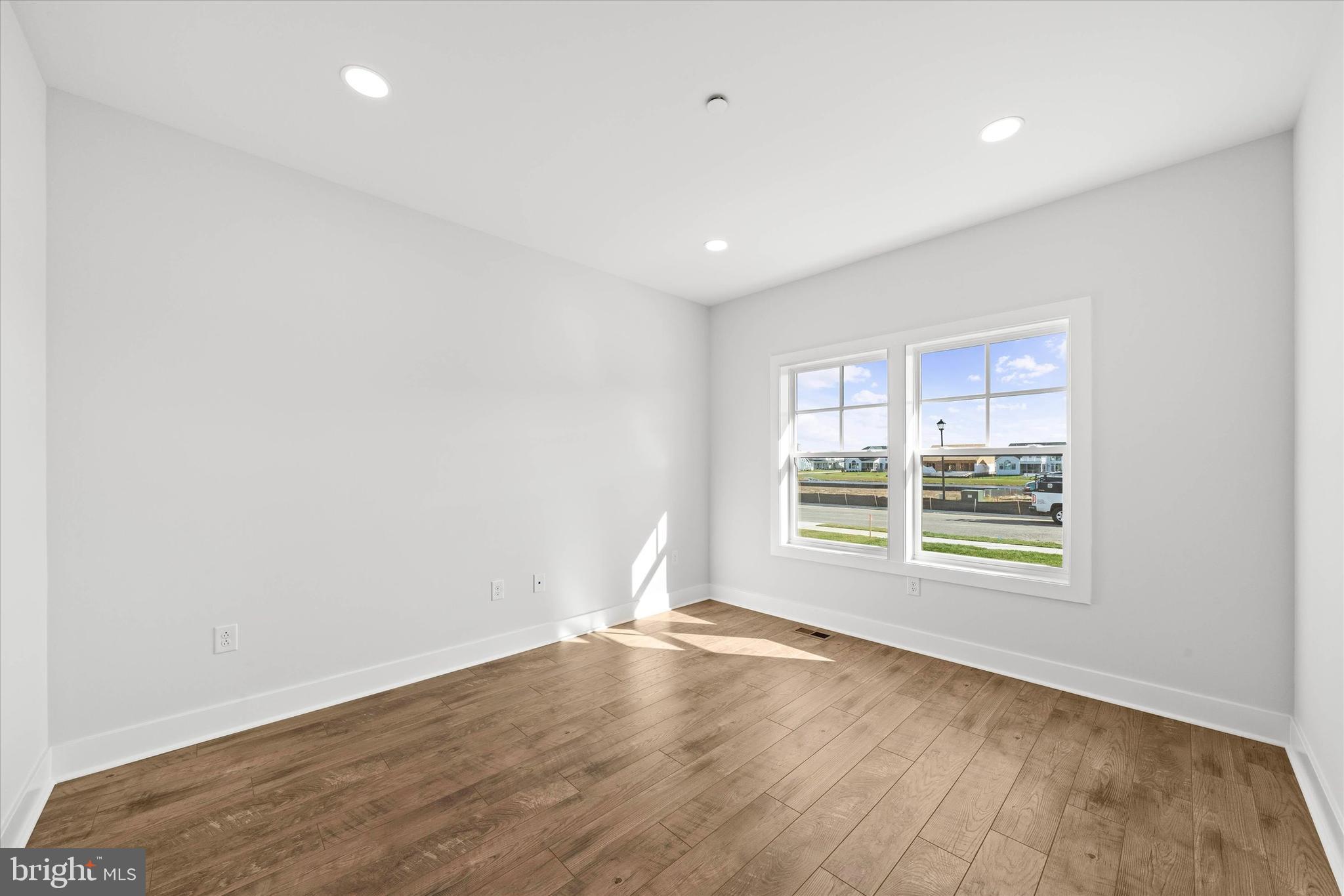 11809 River Run Lane Berlin, MD 21811 - Photo 68 of 95 an empty room with wooden floor and windows