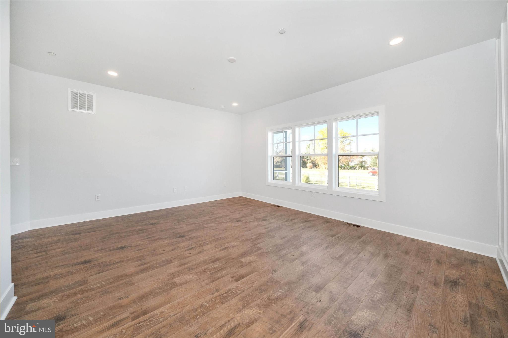 11809 River Run Lane Berlin, MD 21811 - Photo 77 of 95 an empty room with wooden floor and windows