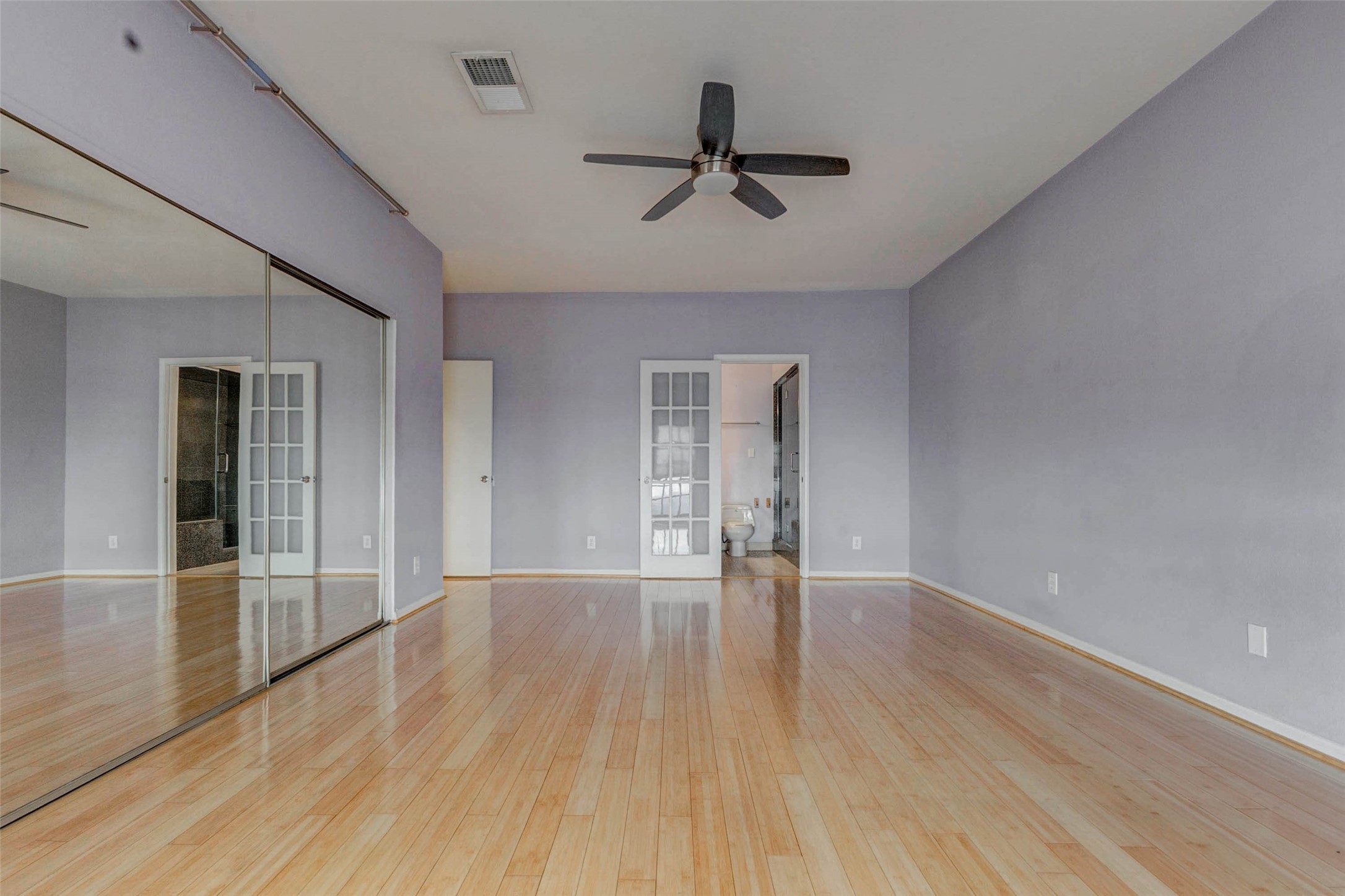 3800 Tanglewilde Street, Unit 102 Houston, TX 77063 - Photo 11 of 28 a view of an empty room with wooden floor and a window