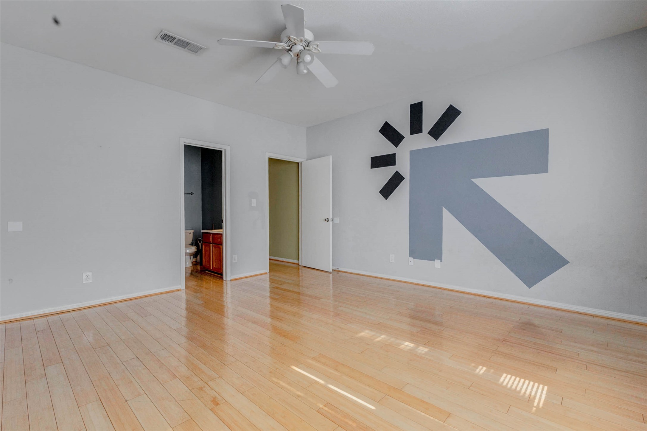 3800 Tanglewilde Street, Unit 102 Houston, TX 77063 - Photo 26 of 28 a view of an empty room with a ceiling fan and wooden floor