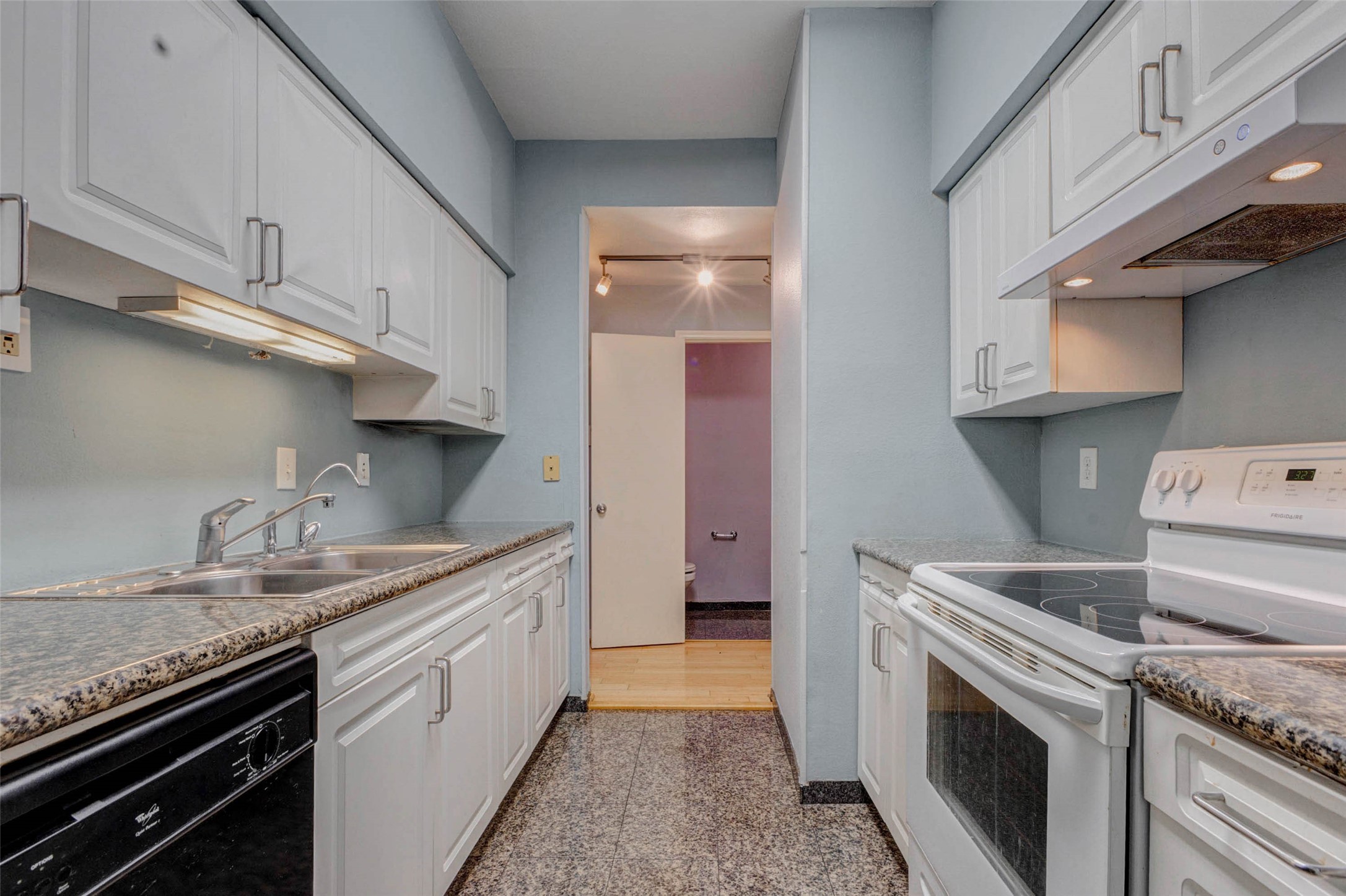 3800 Tanglewilde Street, Unit 102 Houston, TX 77063 - Photo 7 of 28 a kitchen with stainless steel appliances granite countertop a sink stove and cabinets