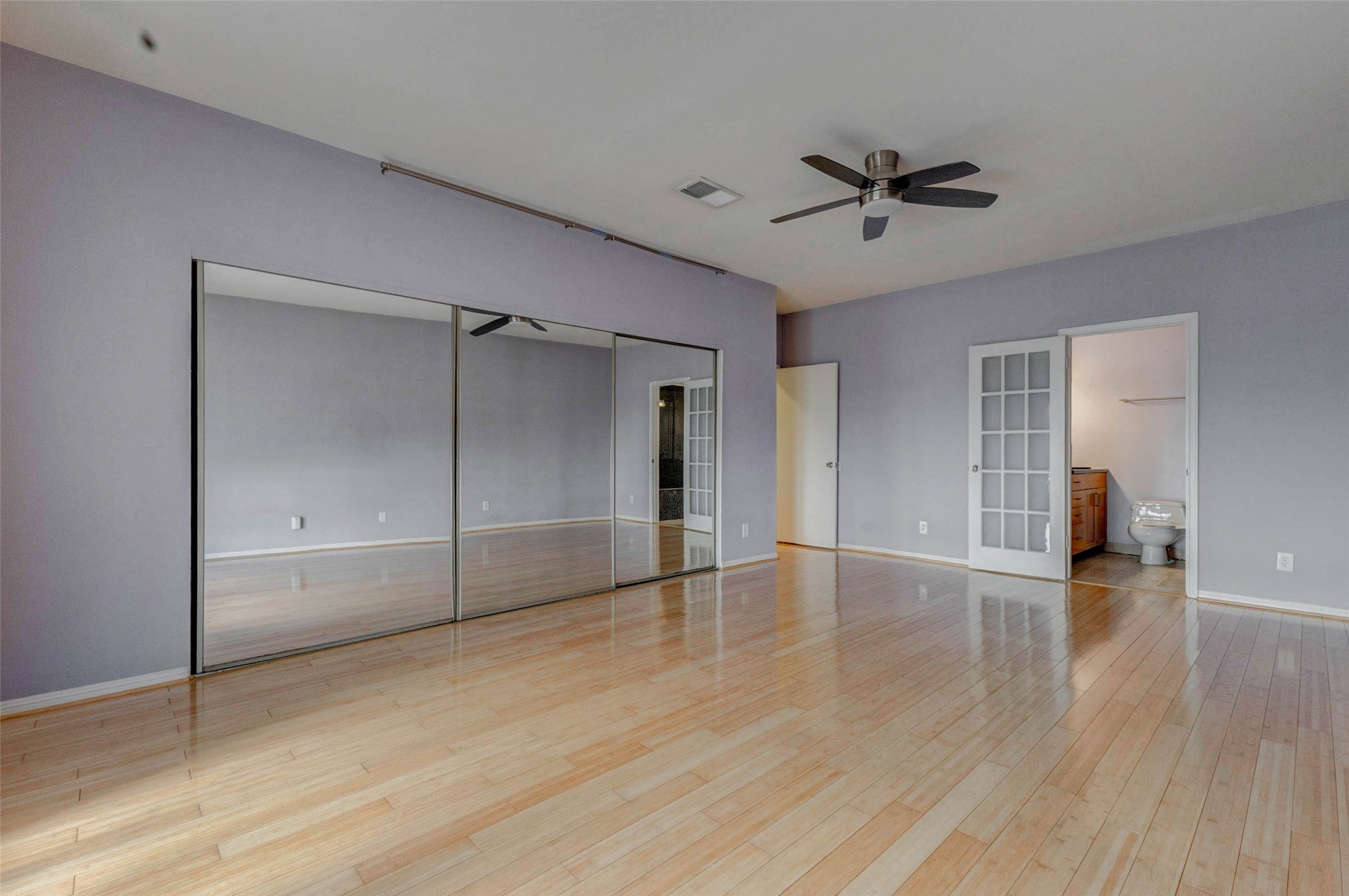 3800 Tanglewilde Street, Unit 102 Houston, TX 77063 - Photo 10 of 28 a view of empty room with wooden floor and ceiling fan