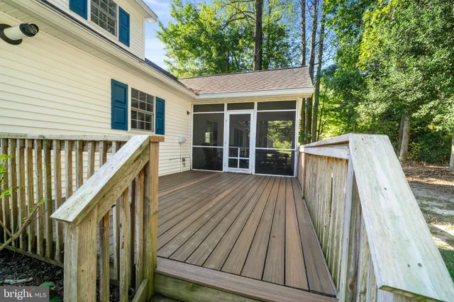 a bedroom with furniture and large windows