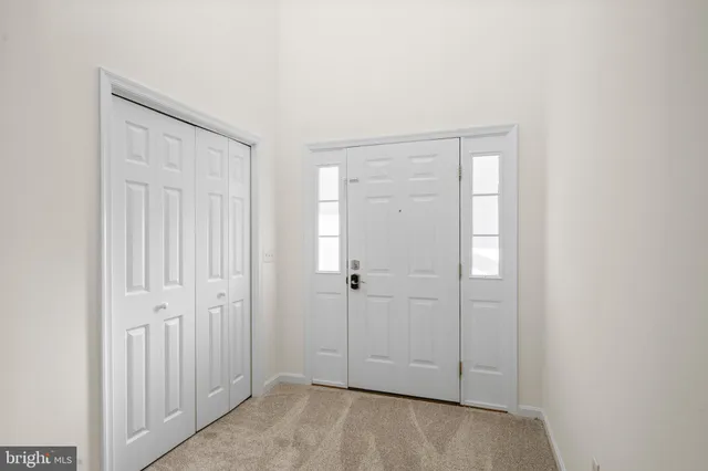 a view of empty room with fireplace and fan