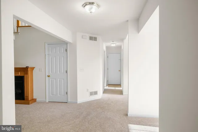 a kitchen with stainless steel appliances a stove a sink cabinets and wooden floor