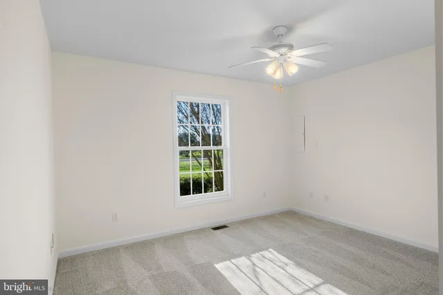 a dining room with furniture and floor to ceiling window