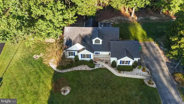 an aerial view of a house with garden space and street view