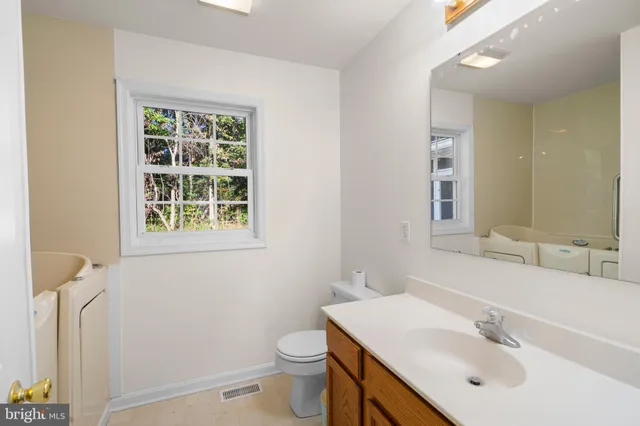 an empty room with closet and wooden floor