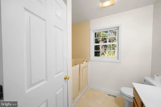 a white toilet sitting next to a bathroom sink