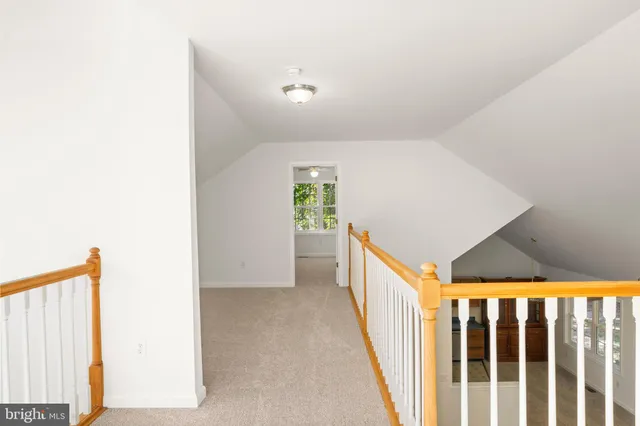 an empty room with a ceiling fan and a fan