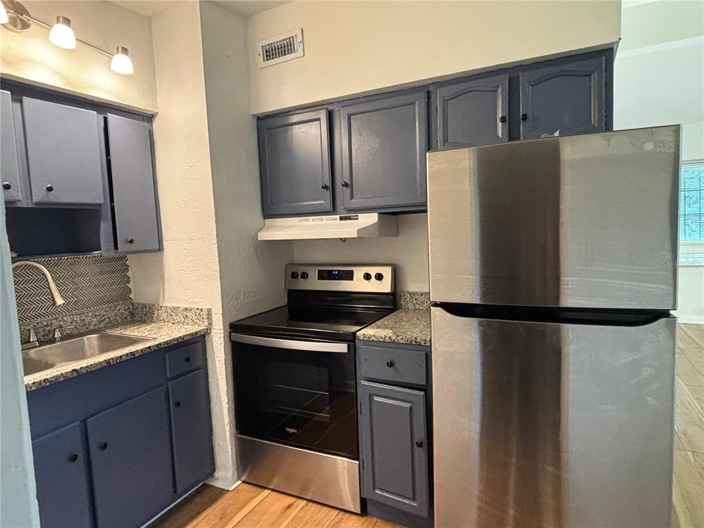 5551 Verbena Road Jacksonville, FL 32209 - Photo 4 of 13 a white refrigerator freezer sitting in a kitchen