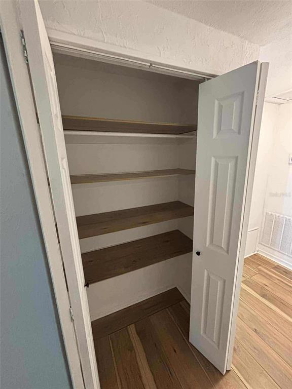 5551 Verbena Road Jacksonville, FL 32209 - Photo 7 of 13 a view of closet with wooden floor and stairs
