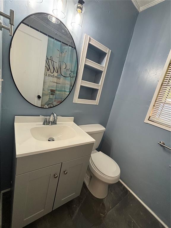 5551 Verbena Road Jacksonville, FL 32209 - Photo 8 of 13 a bathroom with a toilet a sink and mirror