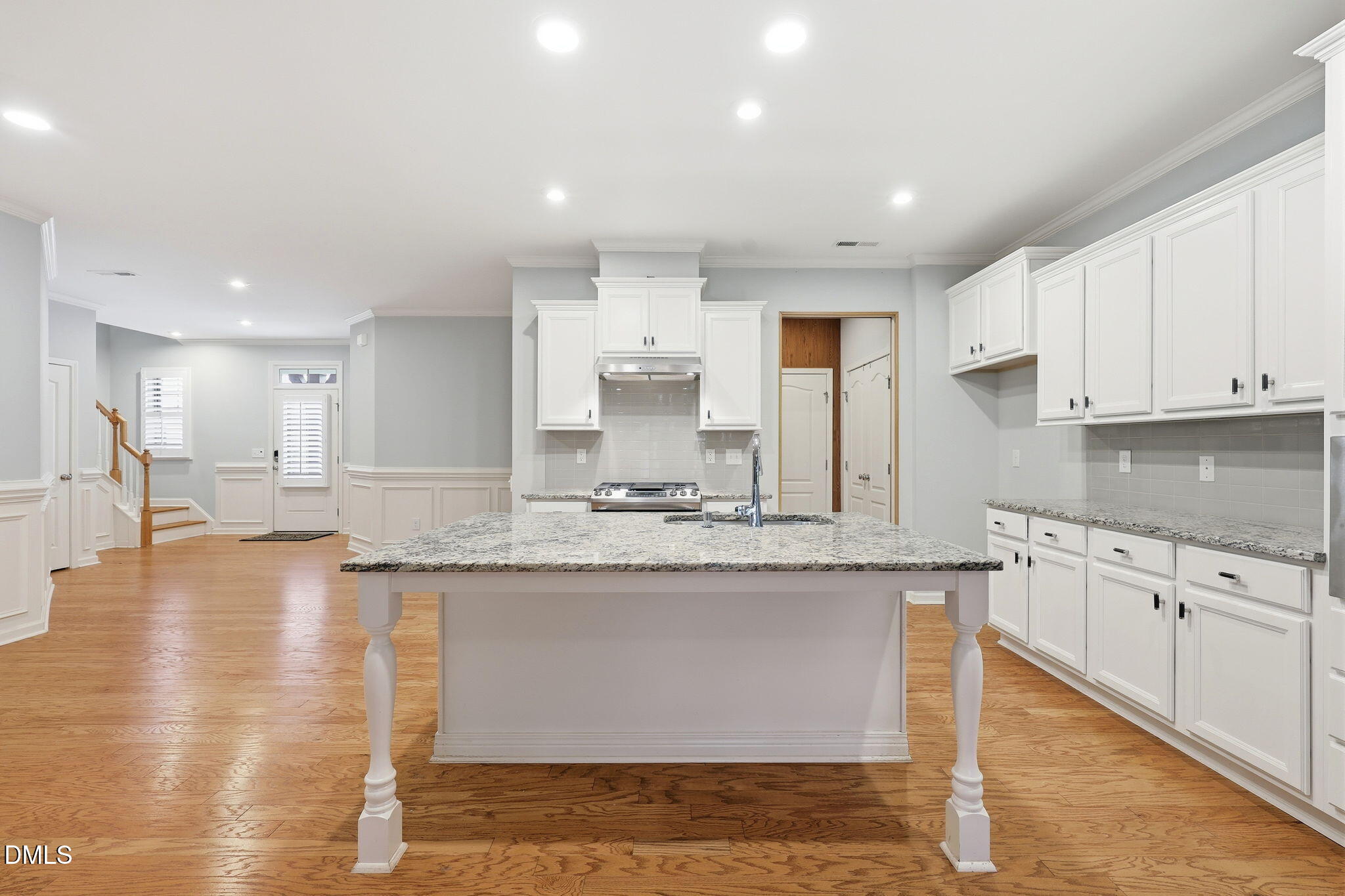 522 Brunello Drive Wake Forest, NC 27587 - Photo 4 of 24 a large kitchen with granite countertop a large counter top and stainless steel appliances