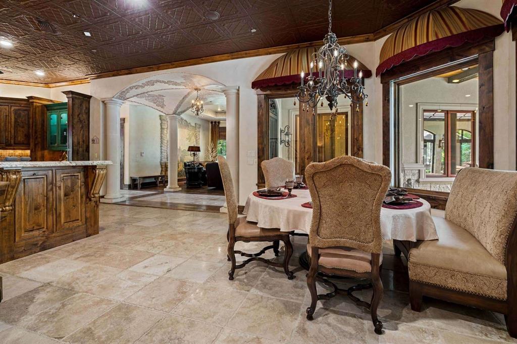 2115 Paradise Rnch Trail McKinney, TX 75071 - Photo 26 of 40 Dining area featuring a decorative ceiling, stone tile flooring, and custom wood trim