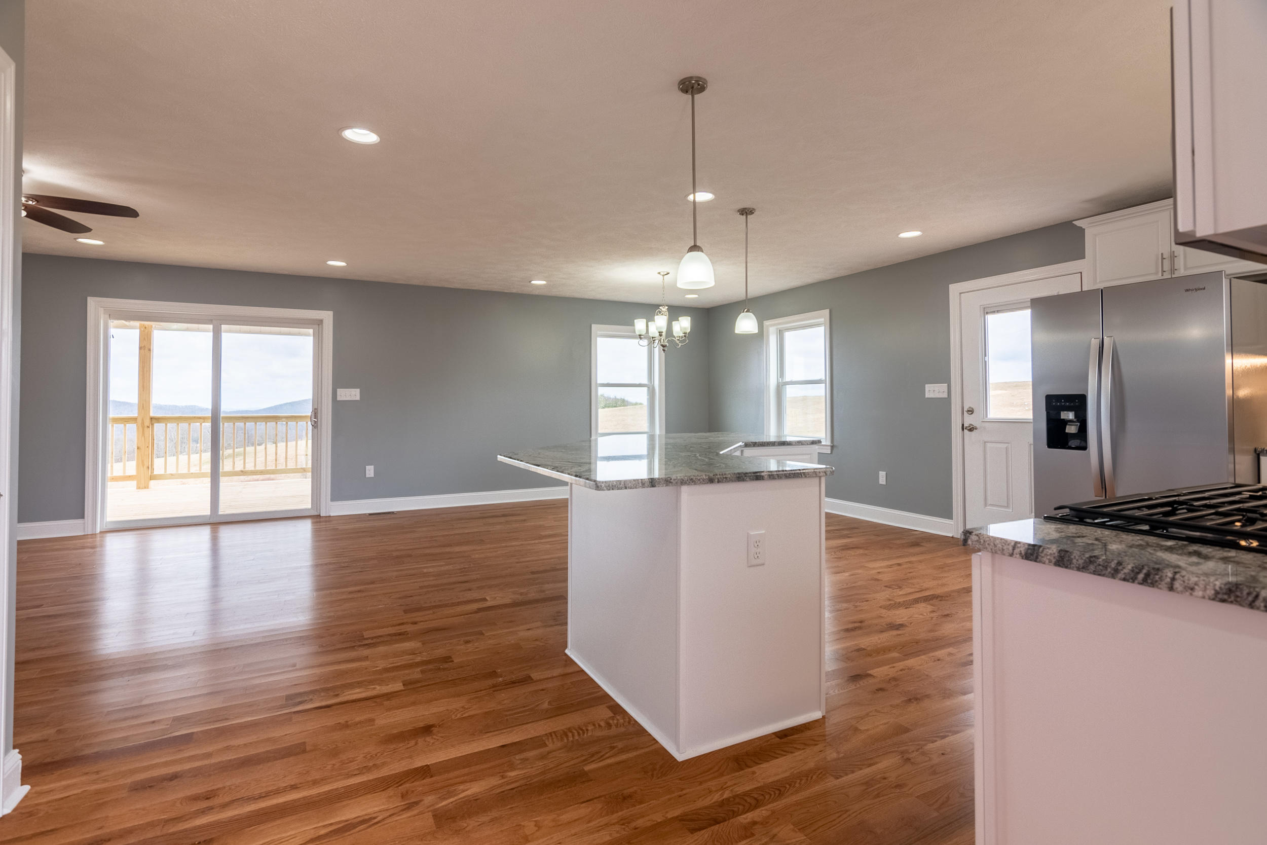 3338 Black Ridge Road Southwest Floyd, VA 24091 - Photo 8 of 38 a large kitchen with stainless steel appliances granite countertop a large counter top and a wooden floor