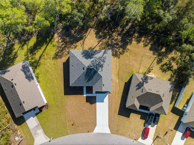 a backyard of a house with table and chairs