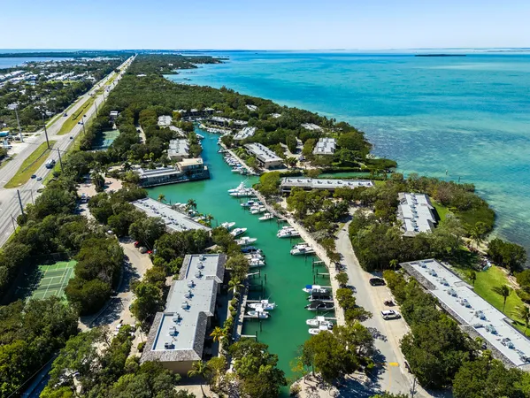 an aerial view of ocean with residential house with outdoor space