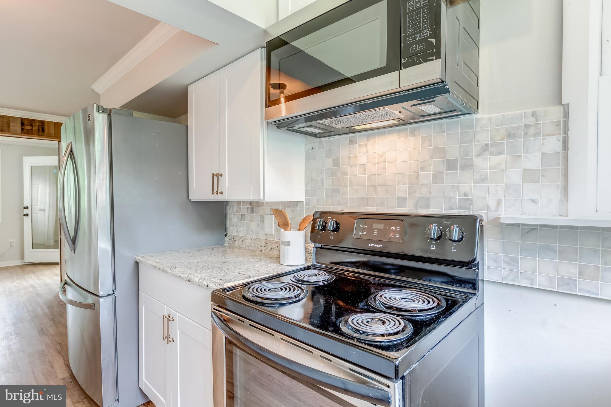 24436 Lenah Road Aldie, VA 20105 - Photo 21 of 39 a stove top oven sitting inside of a kitchen