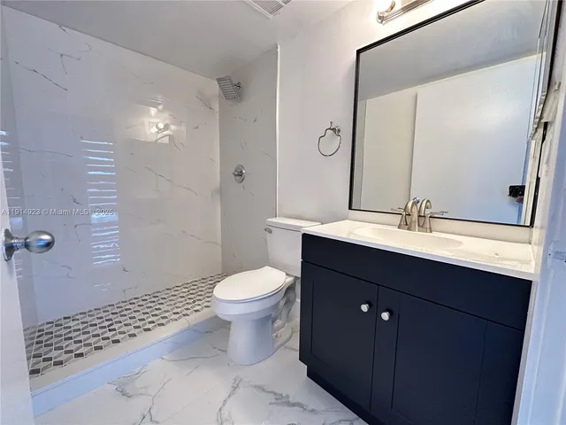 a kitchen with a refrigerator and sink