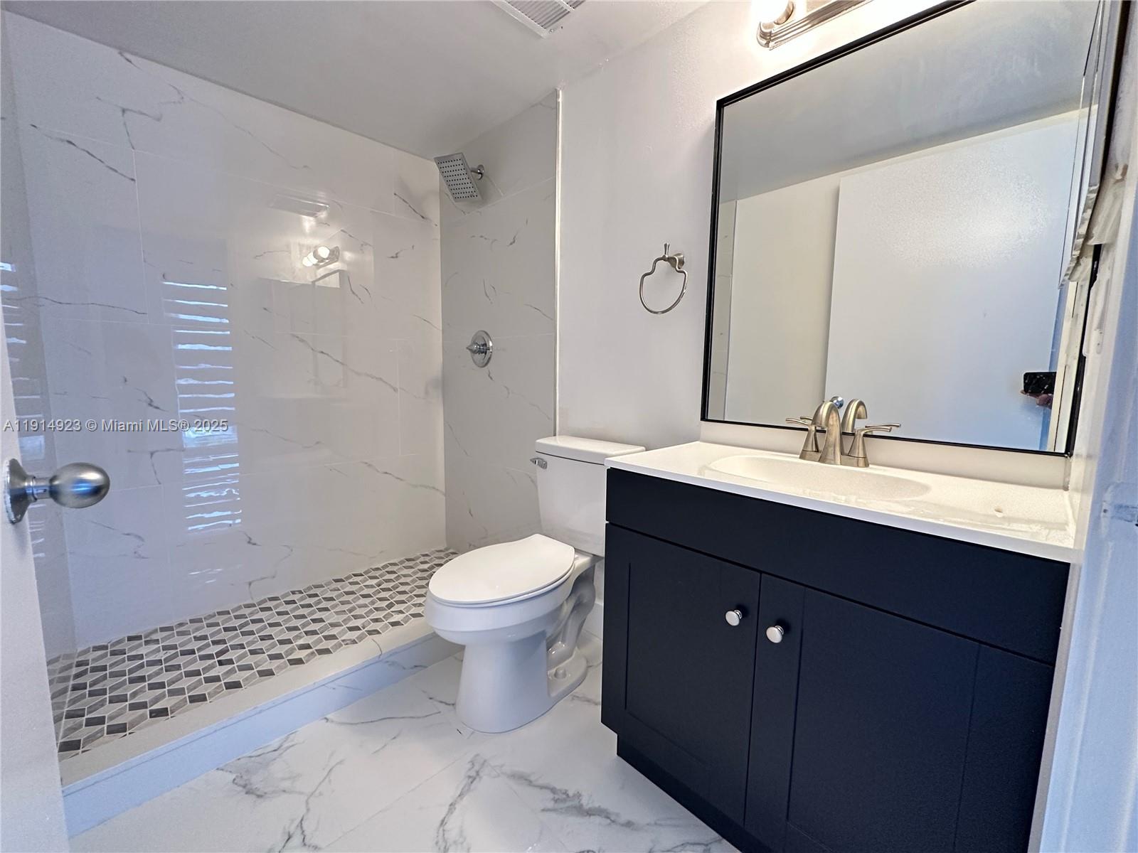 7125 Northwest 186th Street, Unit B311 Hialeah, FL 33015 - Photo 19 of 25 a bathroom with a sink toilet and shower