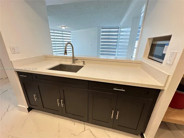 a kitchen with a refrigerator and a stove top oven with wooden floor