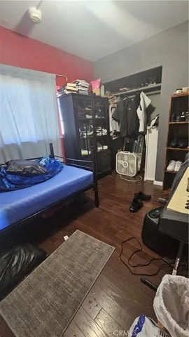 a bedroom with bed and a window