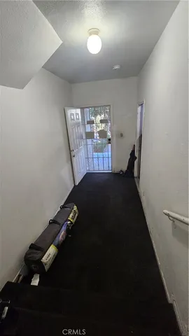 a living room with furniture and hard wood flooring