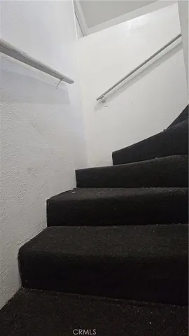 a kitchen with a sink a stove and cabinets