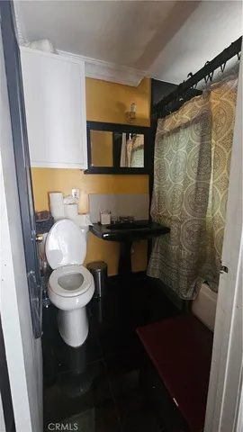a bathroom with a toilet and a shower
