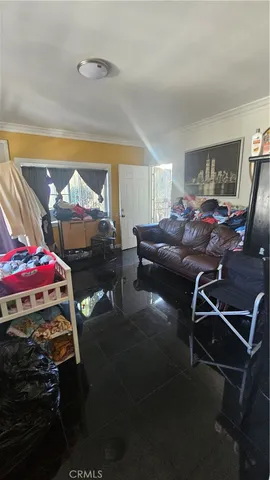 a living room with furniture a window and a flat screen tv