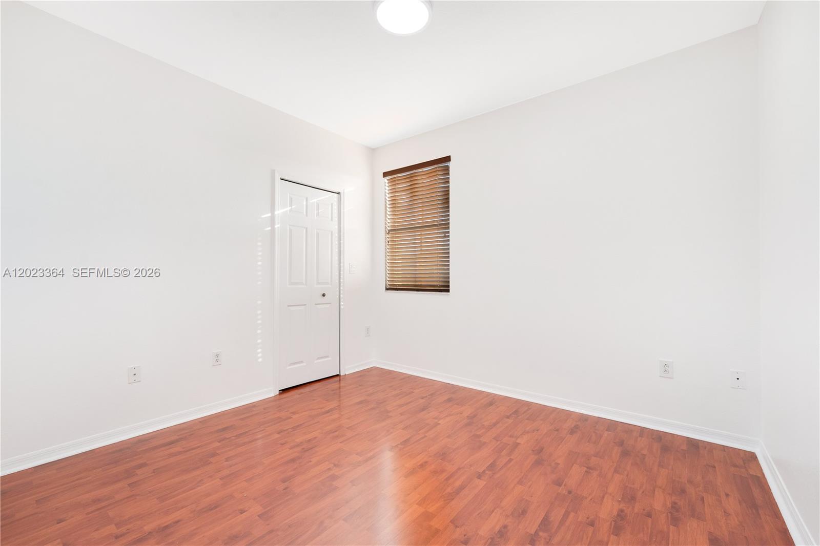 27433 Southwest 137th Court, Unit 1 Homestead, FL 33032 - Photo 11 of 28 a view of empty room with wooden floor