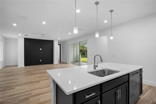 a kitchen with a sink and chandelier