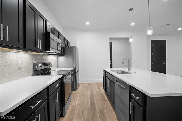 a kitchen with a sink stove and cabinets